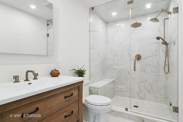 bathroom featuring an enclosed shower, vanity, and toilet