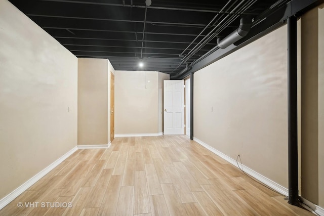 basement with light hardwood / wood-style flooring