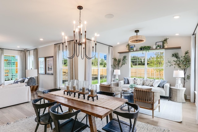 dining space featuring lofted ceiling and light hardwood / wood-style flooring