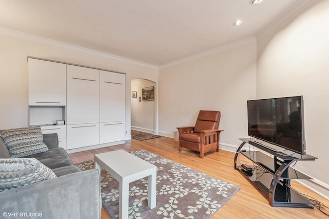 living room with crown molding and light wood-type flooring