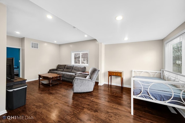 living room featuring wood finished floors, visible vents, and a healthy amount of sunlight