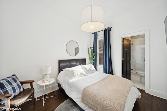 bedroom with connected bathroom and dark hardwood / wood-style flooring