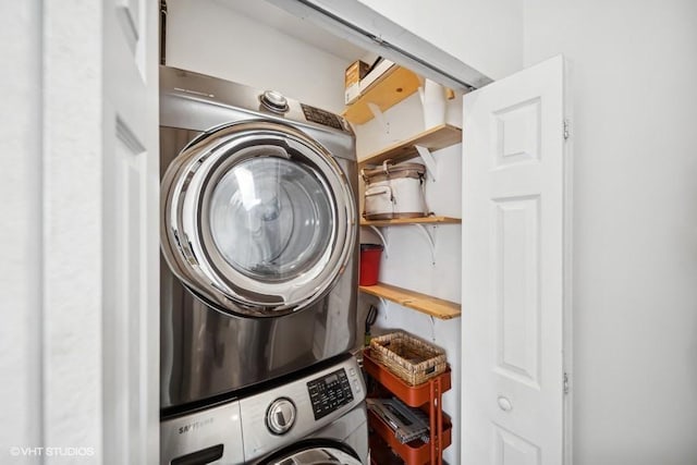 clothes washing area featuring stacked washer / drying machine