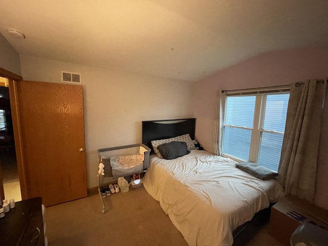 bedroom with vaulted ceiling and carpet