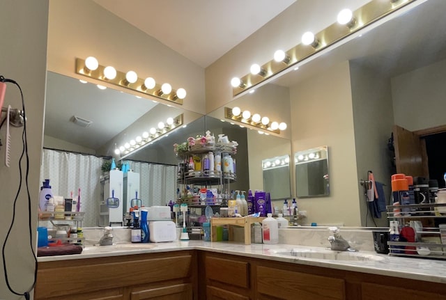 bathroom featuring vanity, vaulted ceiling, and a shower with curtain