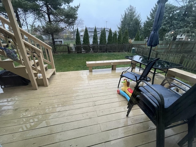 wooden deck featuring a lawn