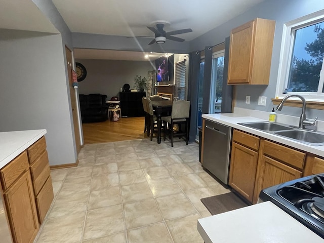 kitchen with ceiling fan, dishwasher, sink, and stove