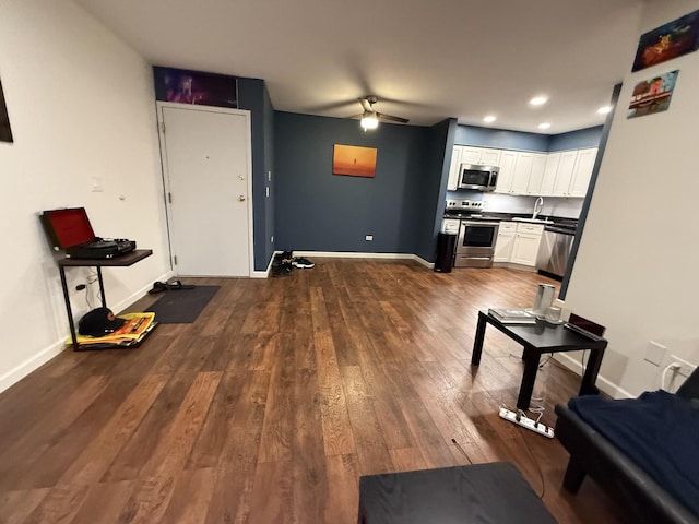 kitchen with dark hardwood / wood-style flooring, ceiling fan, white cabinets, and appliances with stainless steel finishes