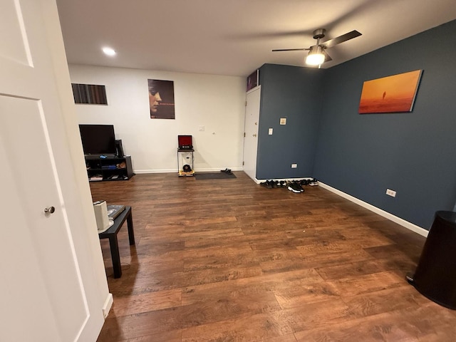 interior space featuring dark wood-type flooring and ceiling fan