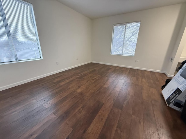 spare room with dark wood-type flooring