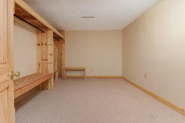 mudroom with light colored carpet