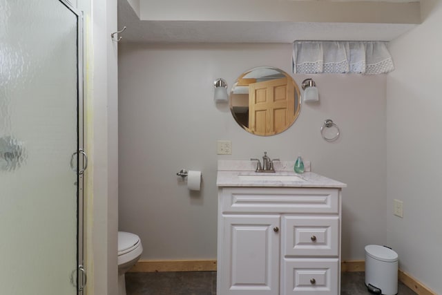 bathroom with vanity, toilet, and a shower with door