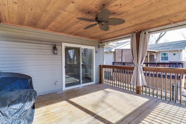 wooden terrace featuring a grill and ceiling fan