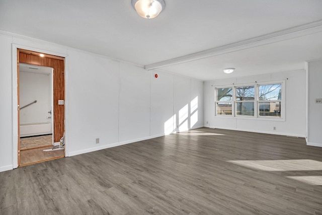 spare room with ornamental molding and hardwood / wood-style floors