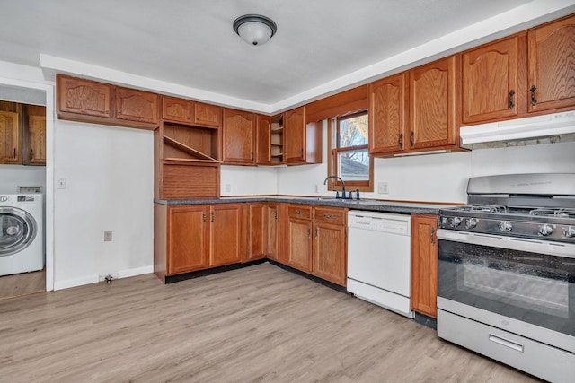 kitchen featuring sink, dishwasher, stainless steel range with gas stovetop, light hardwood / wood-style floors, and washer / clothes dryer