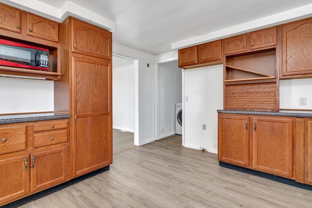 kitchen with washer / clothes dryer and light hardwood / wood-style floors