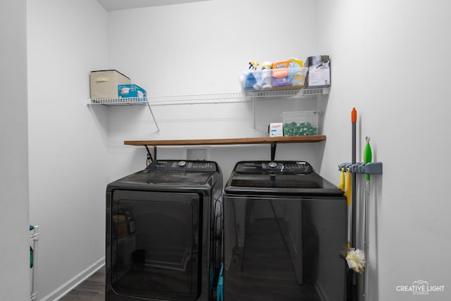 washroom with separate washer and dryer and dark hardwood / wood-style floors