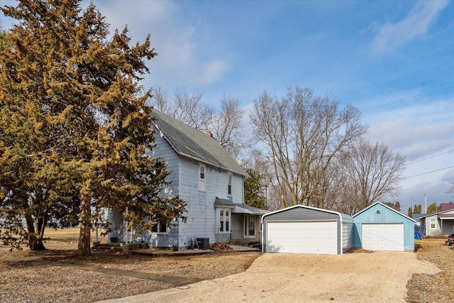 view of front of home featuring a garage and an outdoor structure