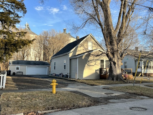 view of front facade featuring a garage and an outdoor structure