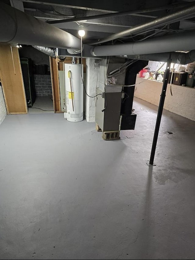 basement with water heater and heating unit