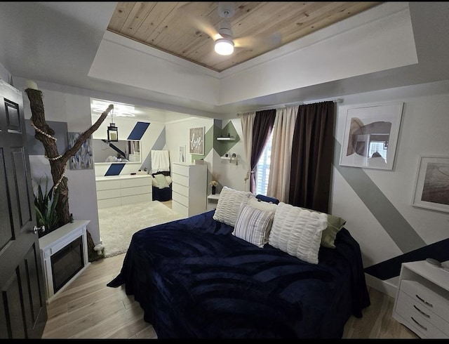 bedroom with a raised ceiling, ceiling fan, wooden ceiling, and light hardwood / wood-style floors