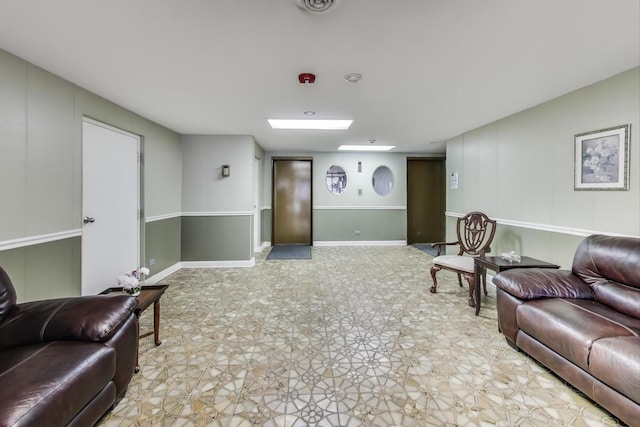 living room with baseboards and light floors