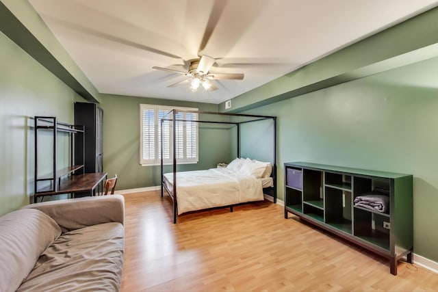 bedroom featuring light wood finished floors, ceiling fan, and baseboards