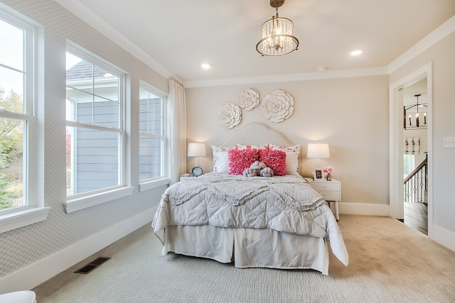 carpeted bedroom featuring an inviting chandelier and crown molding