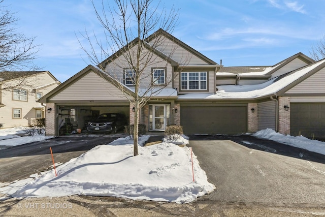 view of front of home with aphalt driveway and brick siding