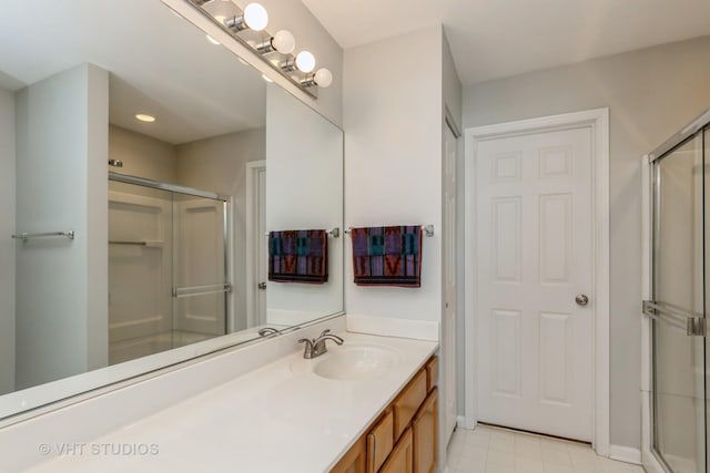 full bathroom with a stall shower, vanity, and recessed lighting