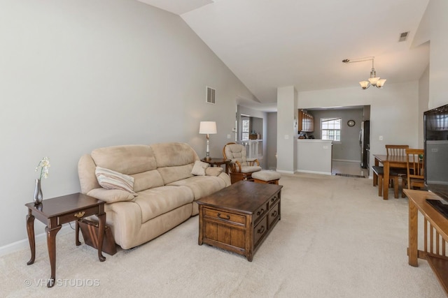 living area featuring light carpet, high vaulted ceiling, visible vents, and baseboards