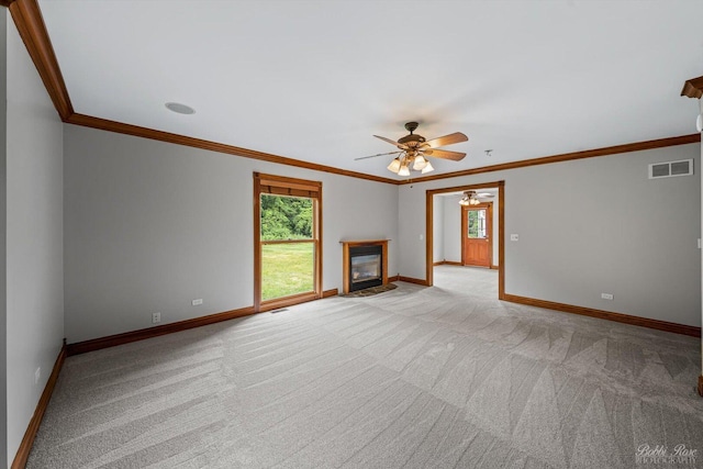6N356 Dunham Rd, Wayne, IL 60184 - unfurnished living room featuring crown molding, ceiling fan, light colored carpet, and a glass covered fireplace