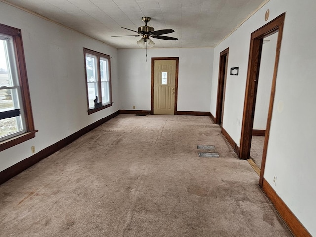 unfurnished room featuring light carpet and ceiling fan