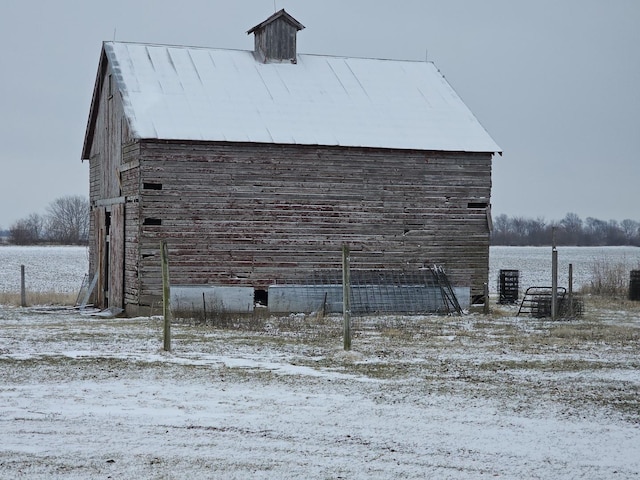 view of property exterior with an outbuilding