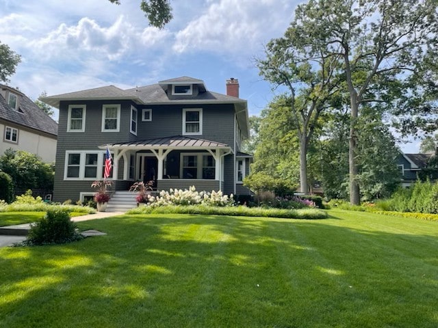 view of front of home featuring a pergola and a front yard