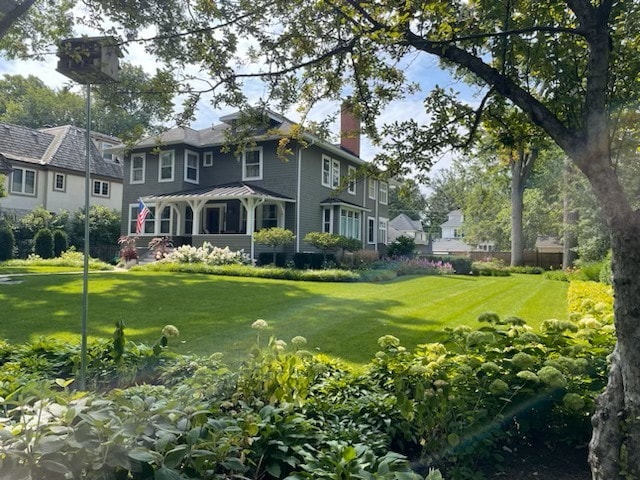 rear view of property featuring a yard