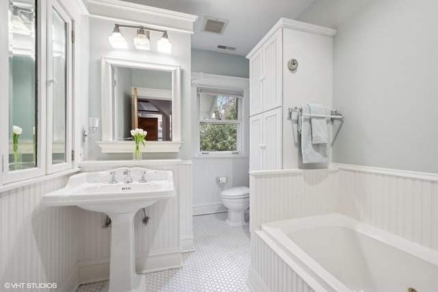 bathroom with toilet and a tub