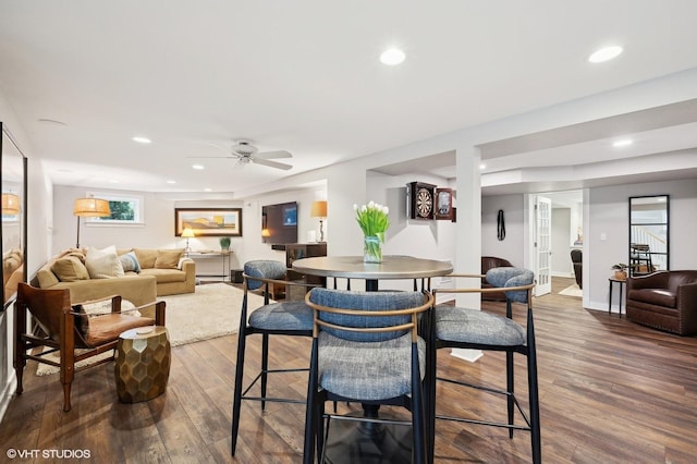 dining space with dark hardwood / wood-style floors and ceiling fan