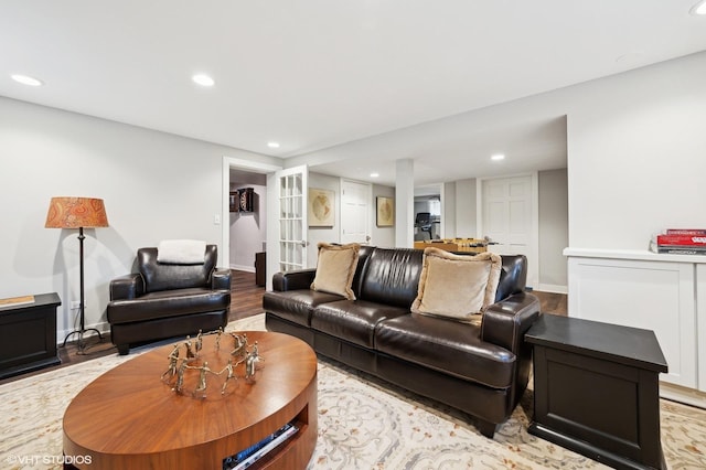 living room with french doors and light wood-type flooring