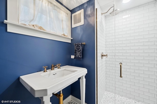 bathroom with sink and a shower with shower door