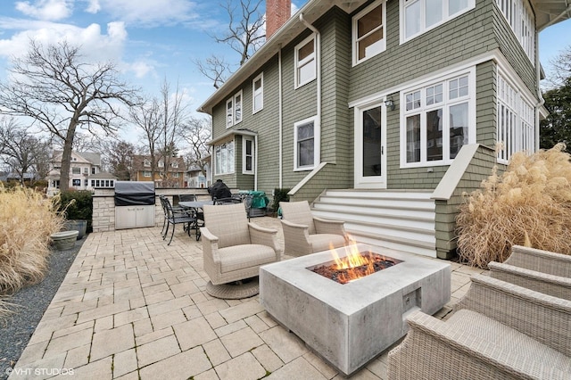 view of patio / terrace featuring a grill and a fire pit