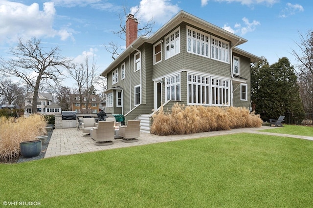 back of house featuring a yard and a patio area