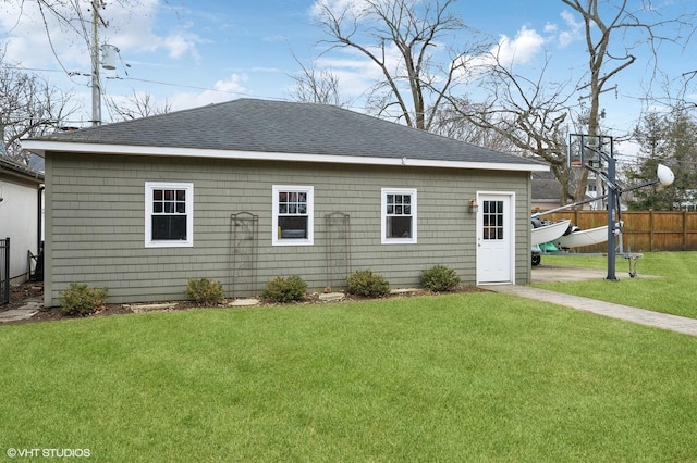 rear view of property with a yard