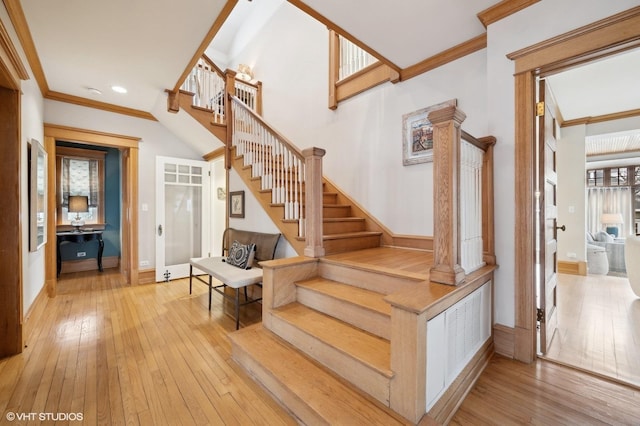 stairway featuring hardwood / wood-style floors and ornamental molding