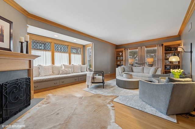 living room with crown molding and light hardwood / wood-style floors