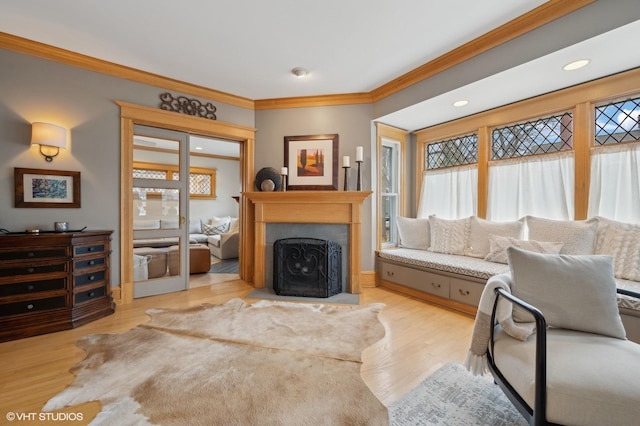 living room with crown molding and light hardwood / wood-style floors