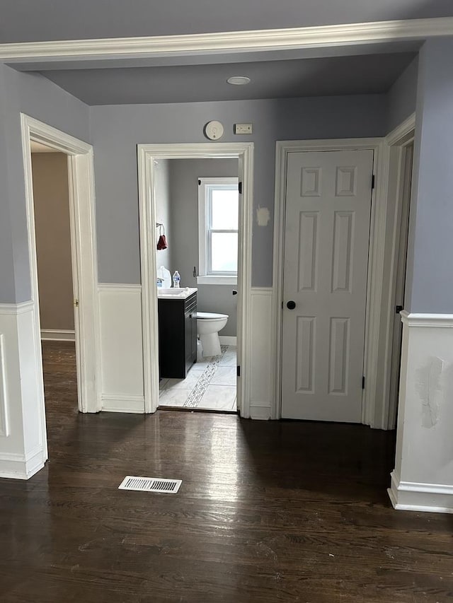 corridor featuring dark hardwood / wood-style flooring and sink