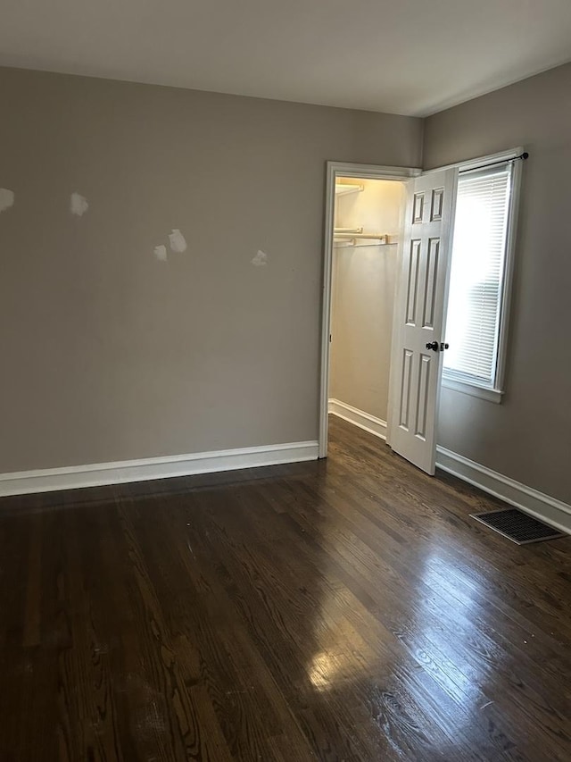 unfurnished room with dark hardwood / wood-style floors