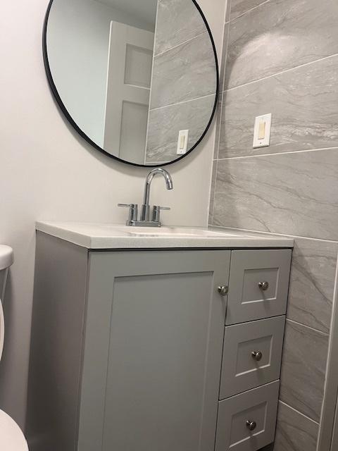 bathroom featuring vanity and toilet