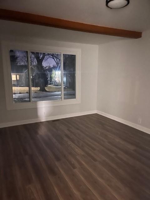 unfurnished room with beamed ceiling and dark hardwood / wood-style flooring